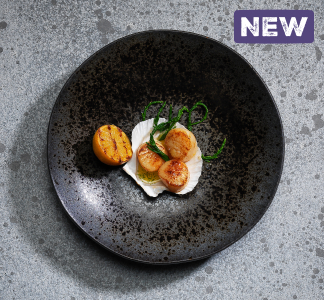 Bar and Block menu item of king scallops with garlic butter in a large black serving dish