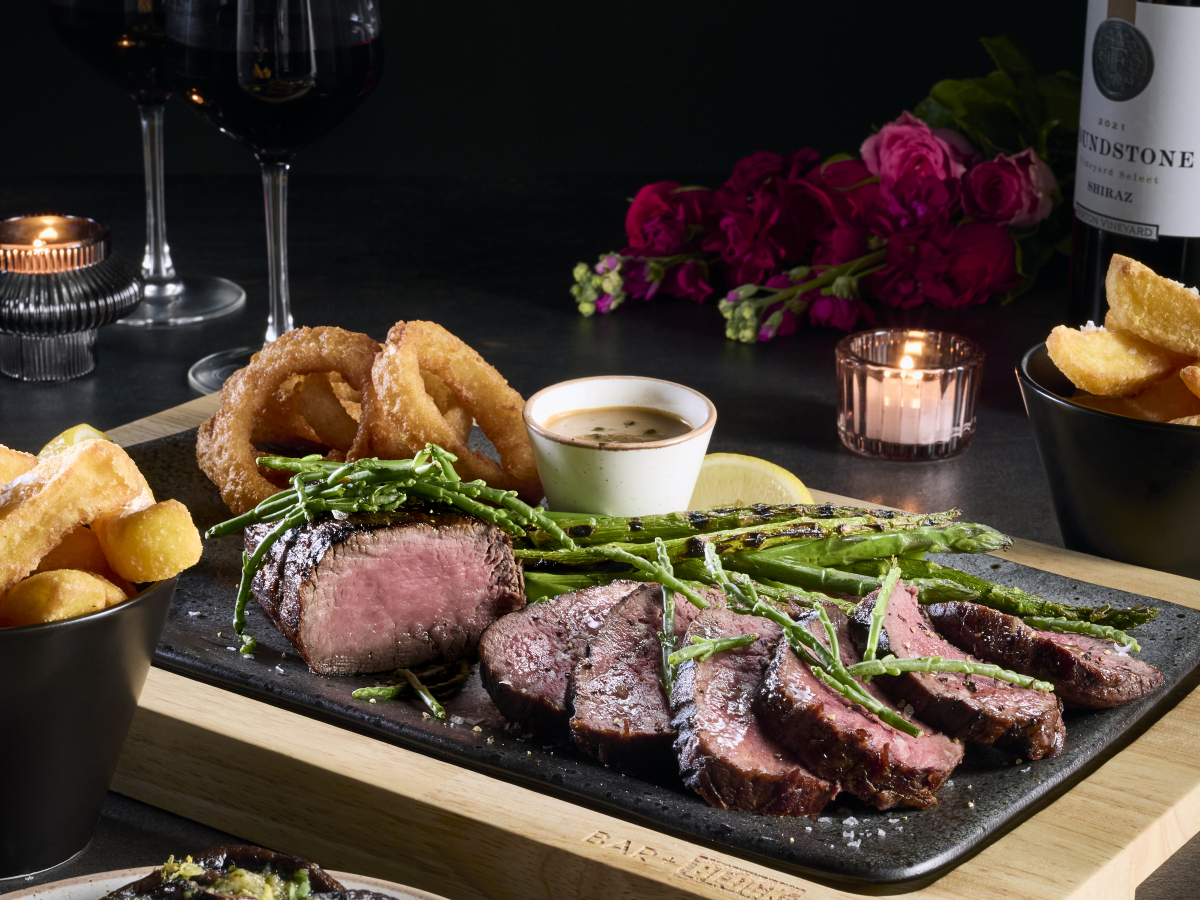 bar and block valentines dishes on table with roses in background