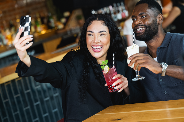 bar + block steakhouse people drinking cocktails and taking selfie